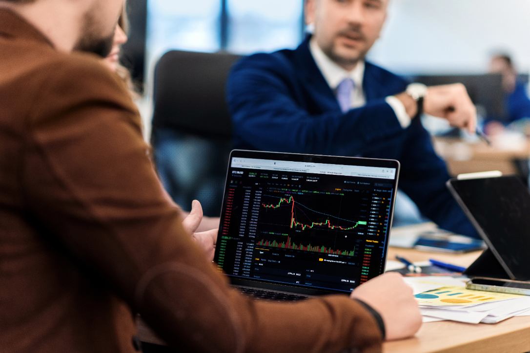 Pregled grafov finančnih naložb na prenosnem računalniku.